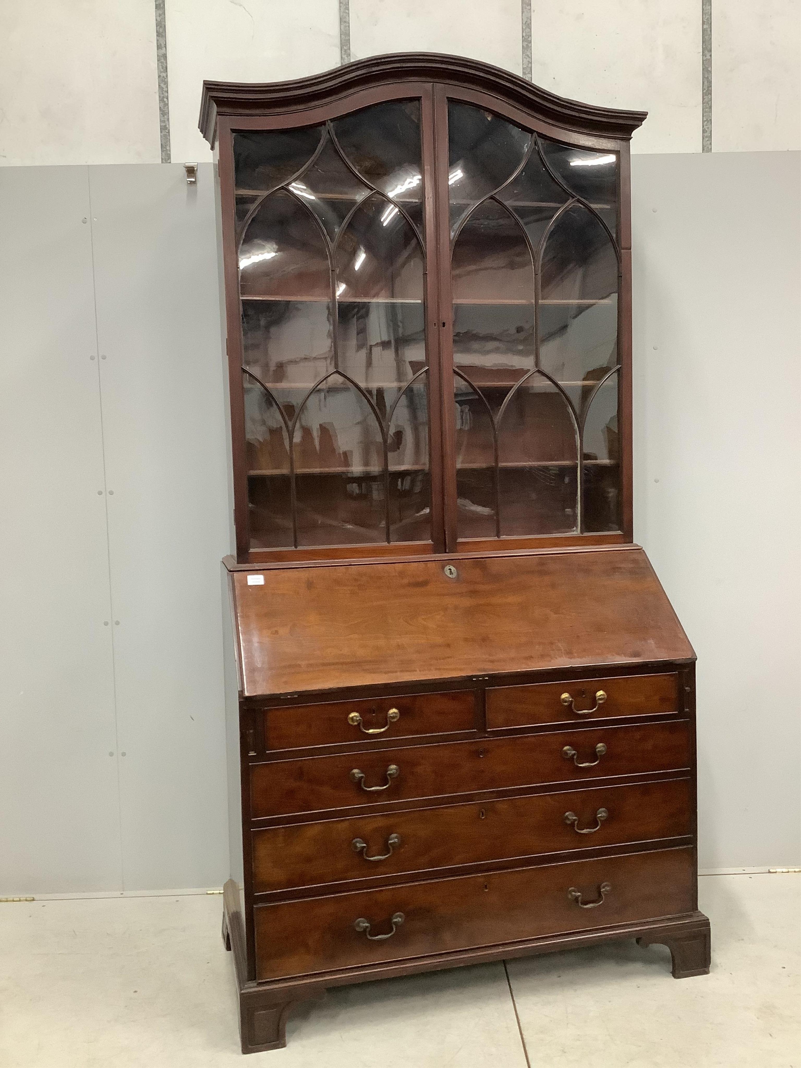 A George III mahogany bureau with associated domed top, width 122cm, depth 60cm, height 250cm. Condition - fair, two bracket feet in need of restoration but pieces present